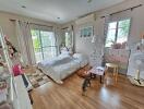 Spacious bedroom with hardwood floors, a double bed, and a balcony view