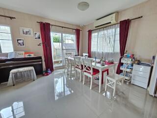 Modern dining room with piano and large windows