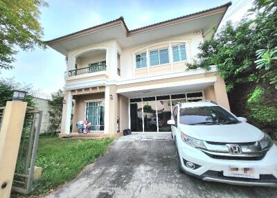 Front view of a two-story residential home with driveway and car parked