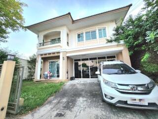 Front view of a two-story residential home with driveway and car parked