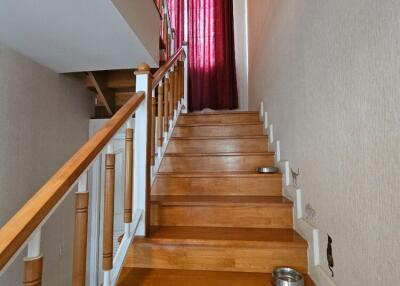 Wooden staircase with red curtains