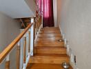 Wooden staircase with red curtains