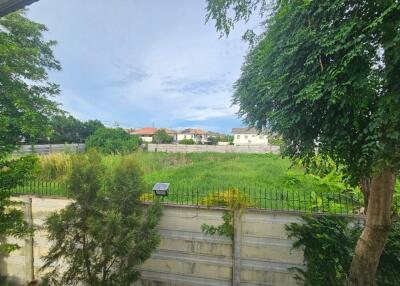 View of backyard with lush green foliage and neighboring houses