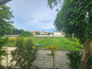 View of backyard with lush green foliage and neighboring houses