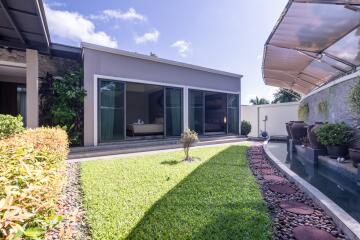 Modern house with garden and water feature