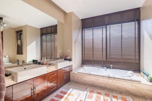 Modern bathroom with double sinks and bathtub