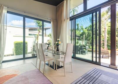 Bright dining area with large windows and garden view