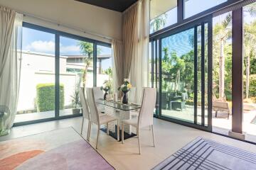 Bright dining area with large windows and garden view