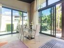 Bright dining area with large windows and garden view