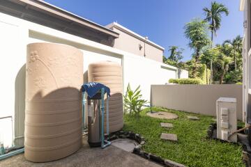 Outdoor area with large water tanks and greenery