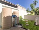 Outdoor area with large water tanks and greenery