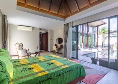 Spacious bedroom with a view of the pool and patio