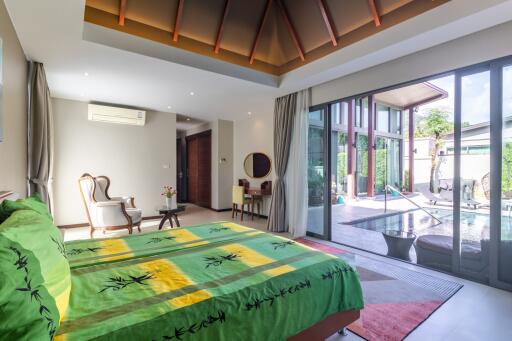 Spacious bedroom with a view of the pool and patio