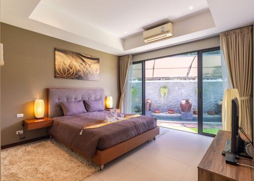 Spacious bedroom with large glass doors to a private outdoor area