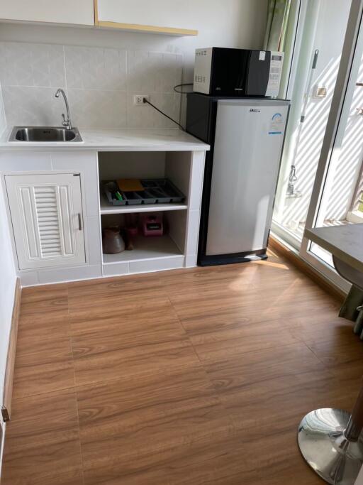 Kitchen with fridge, microwave, sink, and counter space