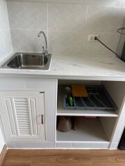 Compact kitchen area with sink and storage