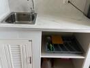 Compact kitchen area with sink and storage