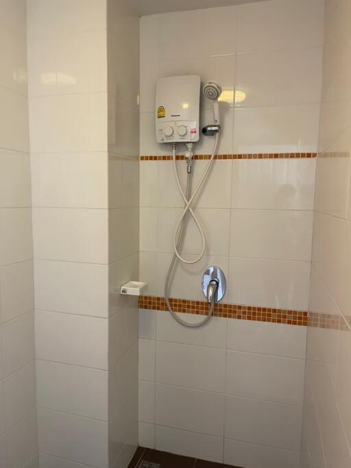 Bathroom shower area with water heater