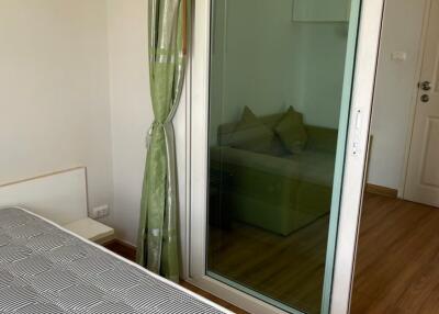 Bedroom with sliding glass door leading to another room