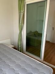 Bedroom with sliding glass door leading to another room