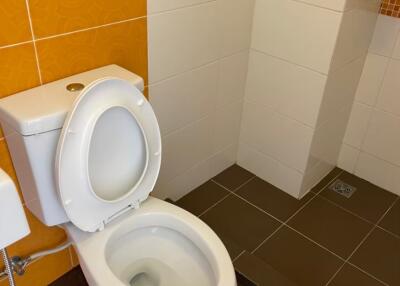 Modern bathroom with toilet and tiled flooring