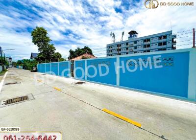 Street view of the property with a blue wall