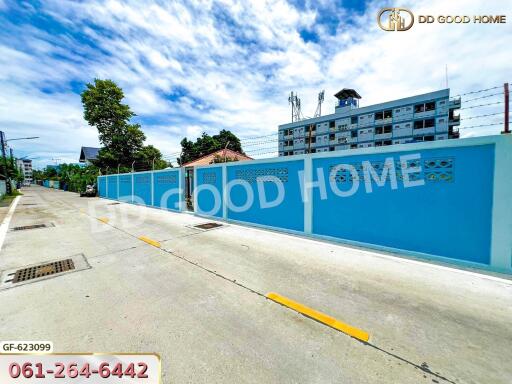 Street view of the property with a blue wall