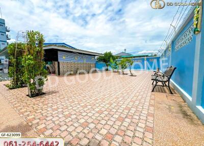 Spacious outdoor area with paved brick ground and seating