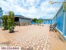 Spacious outdoor area with paved brick ground and seating