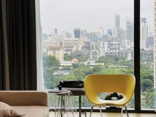 Living area with large window offering city views