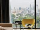 Living area with large window offering city views