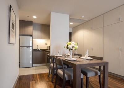 Modern kitchen and dining area with wooden dining table and chairs