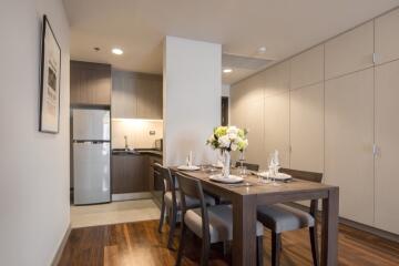 Modern kitchen and dining area with wooden dining table and chairs