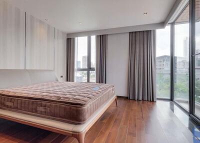 Spacious bedroom with city view and wooden flooring