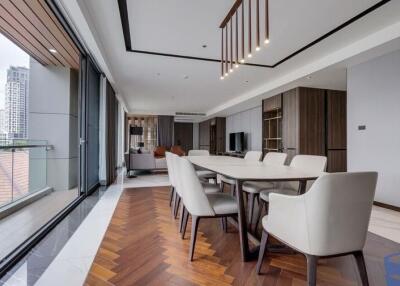 Modern open-plan living and dining area with city view