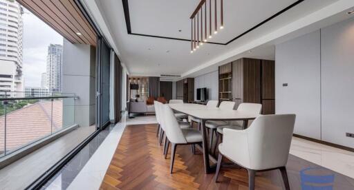 Modern open-plan living and dining area with city view