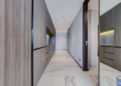 Modern hallway with wooden cabinetry and marble flooring