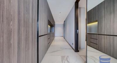 Modern hallway with wooden cabinetry and marble flooring