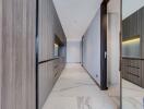 Modern hallway with wooden cabinetry and marble flooring