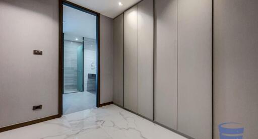 Modern hallway with built-in storage and tile flooring