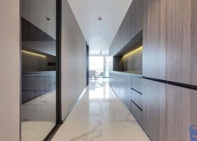 Modern hallway with sleek storage cabinets and glass partition