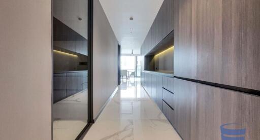 Modern hallway with sleek storage cabinets and glass partition