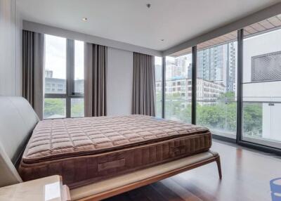 Modern bedroom with large windows and city view