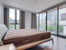 Modern bedroom with large windows and city view