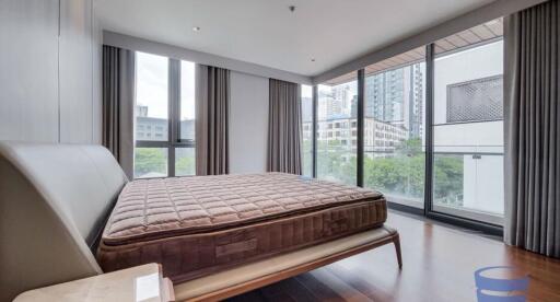 Modern bedroom with large windows and city view