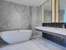 Modern bathroom with marble walls and freestanding bathtub