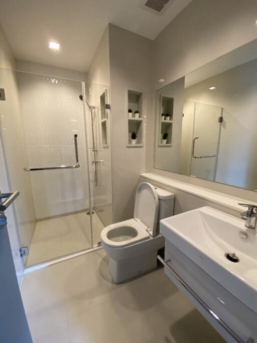 Modern bathroom with shower, toilet, and sink