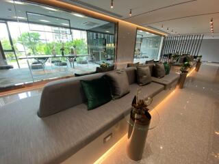 Modern lobby area with long seating and glass walls