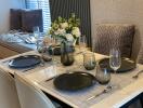 Elegantly set dining table with black plates and wine glasses