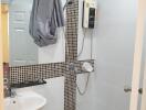 Bathroom with shower area, sink, and water heater